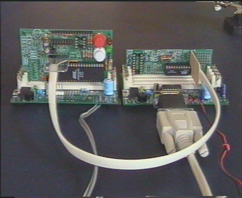 Photo showing complete programmer setup. On the right is a Dontronics DT004 motherboard supplying power to a Dontronics DT103 40 pin Atmel target board.